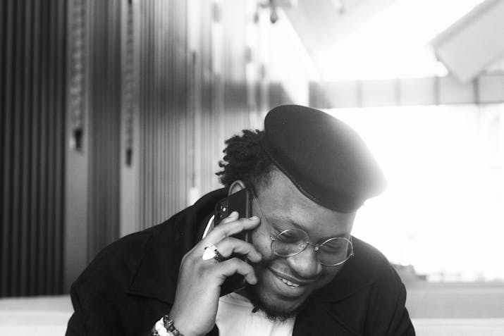 Facts About Orange Dot On Iphone 3 Smiling man wearing glasses and beret talking on iPhone
