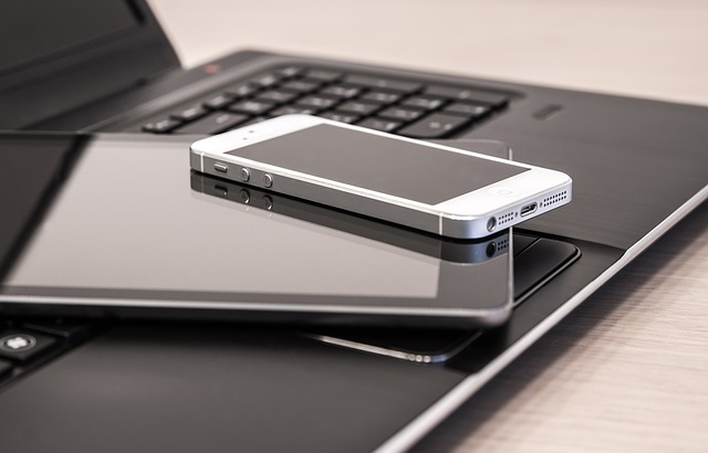 Unlock the Power of iPhone USB Tethering 4 Stack of iPhone and iPad placed on laptop keyboard
