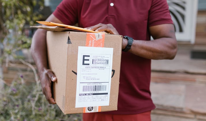 How to Return an Item to JCPenney 3 Courier holding a USPS Express Mail package for delivery.