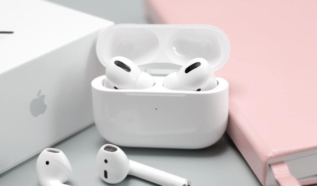 Apple AirPods Pro in open MagSafe charging case on a desk