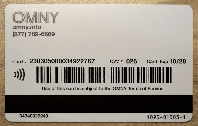 Back of an OMNY transit card with card number, CVV, expiry, barcodes, and contactless symbol