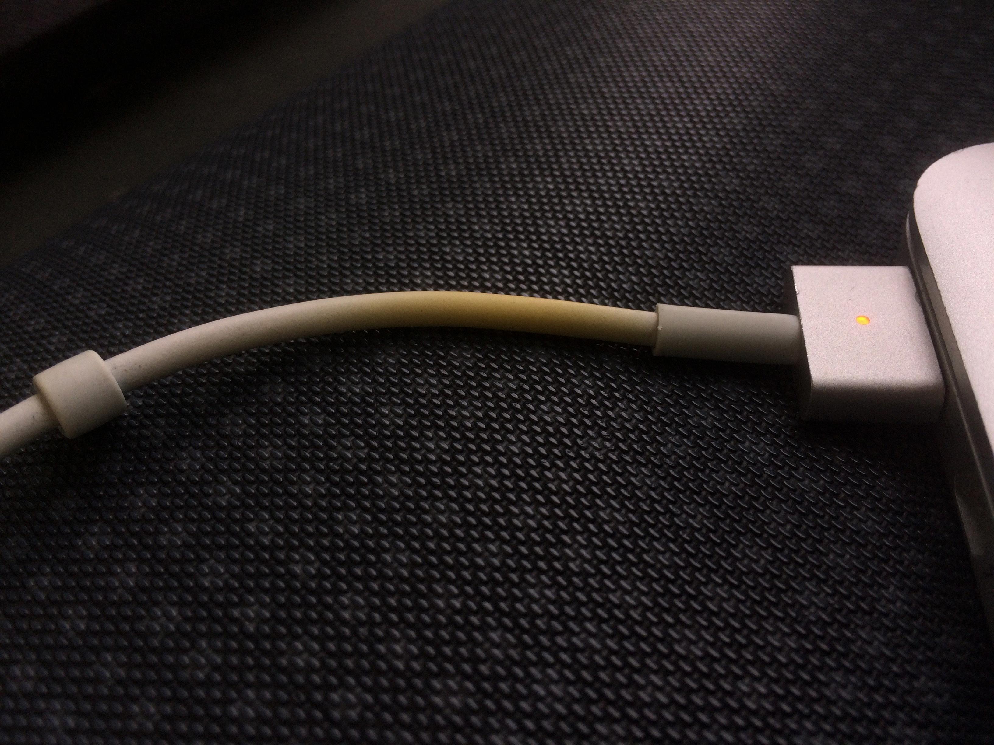 why does mac charger turn orange