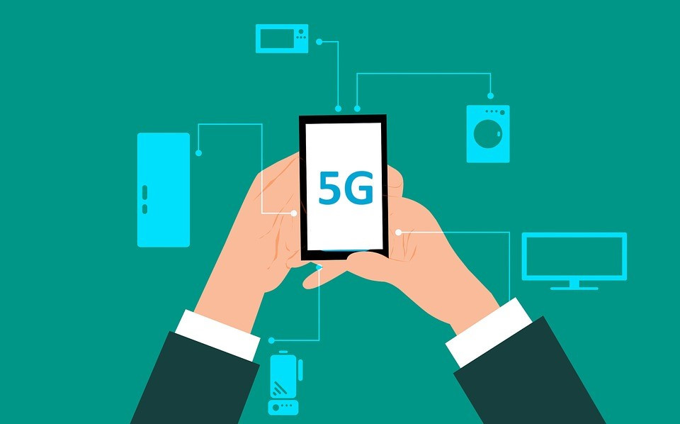 A diagram of a corporate worker holding a phone that says 5G with lines pointing to interconnected devices.